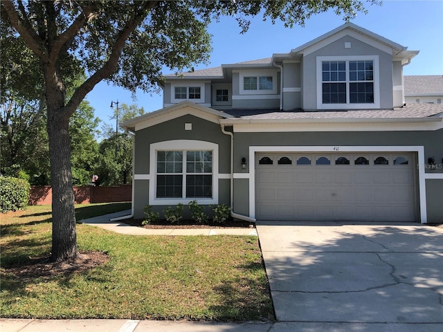 view of front of house with a front yard and a garage