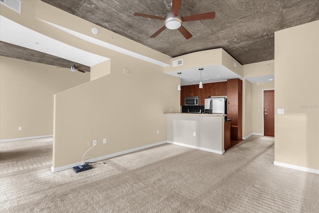 interior space featuring ceiling fan, carpet floors, stainless steel appliances, and kitchen peninsula