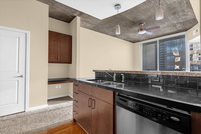 kitchen with hanging light fixtures, sink, stainless steel dishwasher, light colored carpet, and ceiling fan