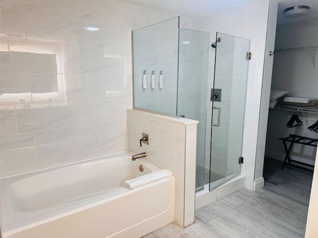 bathroom with independent shower and bath and tile patterned floors