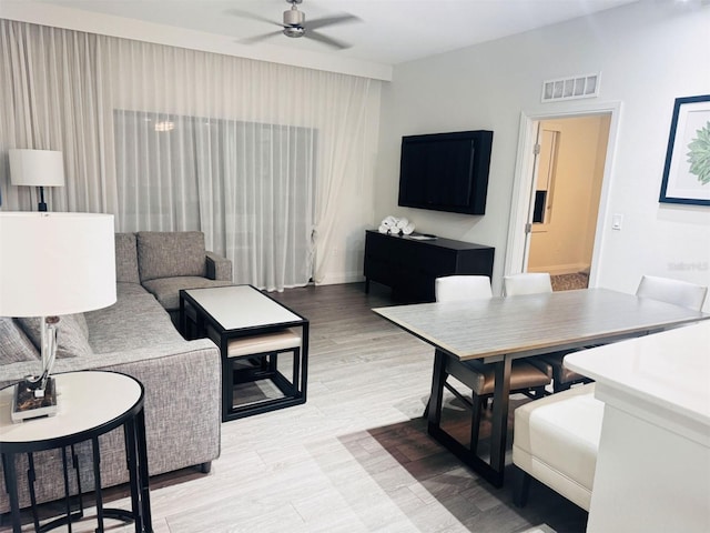 living room with ceiling fan and light hardwood / wood-style floors