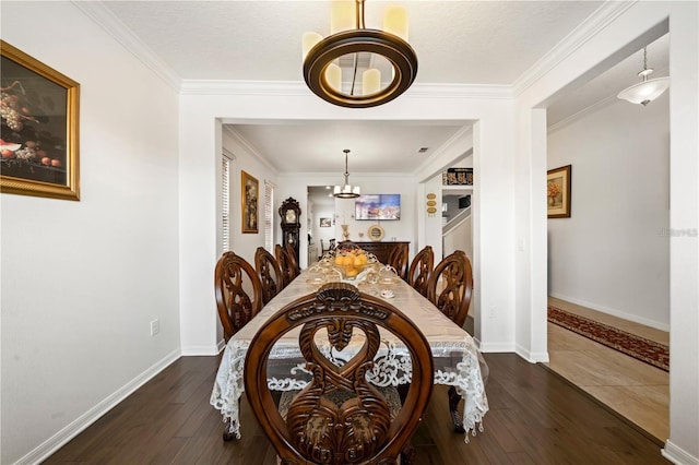 dining space featuring dark hardwood / wood-style floors and crown molding