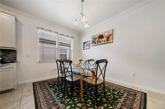 tiled dining room with a textured ceiling, ornamental molding, and an inviting chandelier