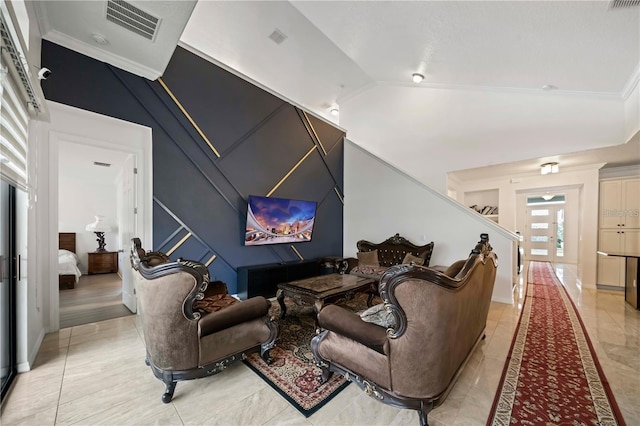 living room featuring vaulted ceiling, crown molding, and light tile floors