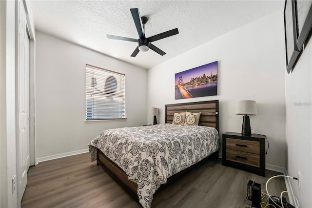 bedroom featuring a textured ceiling, dark wood-type flooring, a closet, and ceiling fan