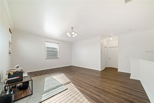 unfurnished room with a notable chandelier, ornamental molding, and dark hardwood / wood-style flooring