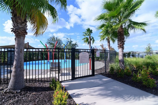 view of gate featuring a community pool