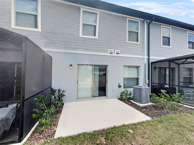 rear view of house featuring a patio and central air condition unit