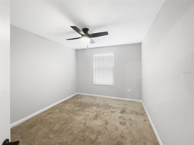 empty room featuring ceiling fan and carpet floors