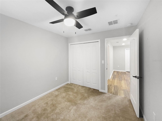 unfurnished bedroom featuring a closet, ceiling fan, and carpet flooring