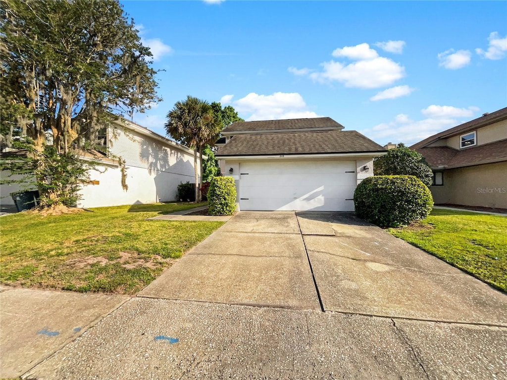 view of front facade featuring a front lawn and a garage