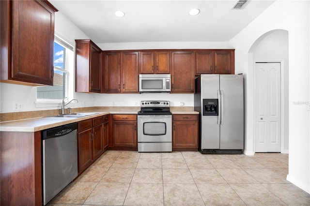 kitchen with light tile patterned floors, light countertops, visible vents, appliances with stainless steel finishes, and a sink