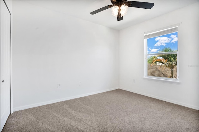 empty room with carpet floors, ceiling fan, and baseboards