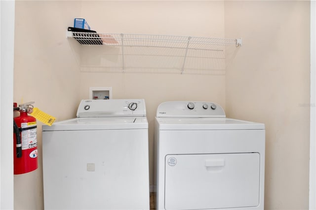 washroom with laundry area and independent washer and dryer