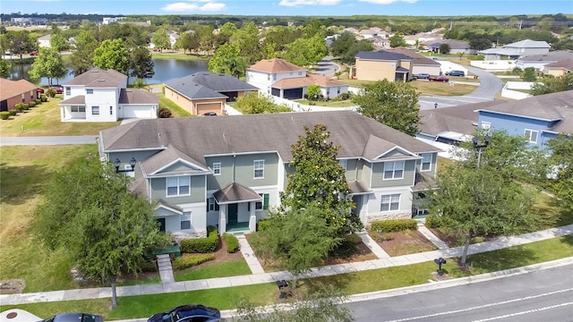 drone / aerial view with a water view and a residential view