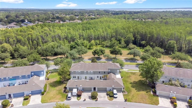 birds eye view of property featuring a wooded view