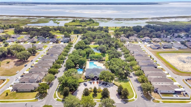 birds eye view of property with a water view and a residential view