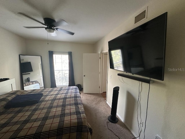 unfurnished bedroom featuring carpet, multiple windows, and ceiling fan