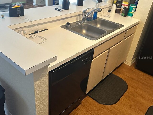 kitchen with light brown cabinets, light hardwood / wood-style floors, dishwasher, sink, and refrigerator