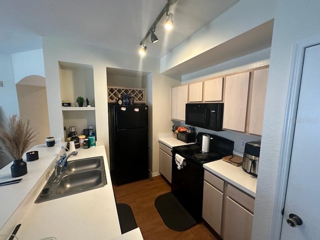 kitchen with dark hardwood / wood-style flooring, black appliances, sink, track lighting, and light brown cabinets