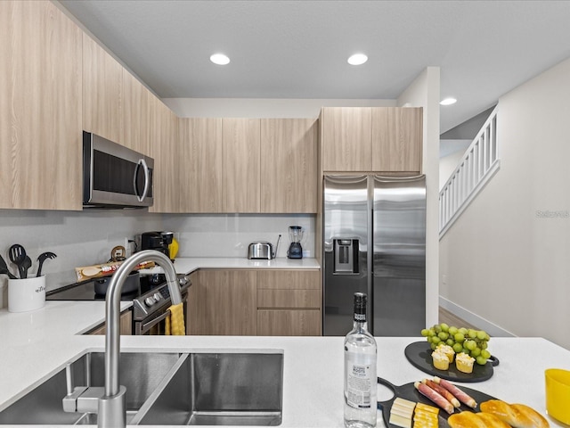 kitchen with light brown cabinets, sink, and stainless steel appliances