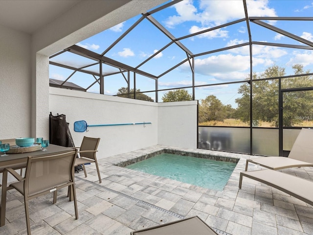 view of swimming pool with a patio area and a lanai