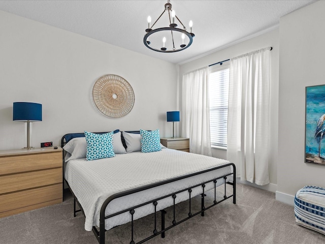 bedroom with carpet and an inviting chandelier