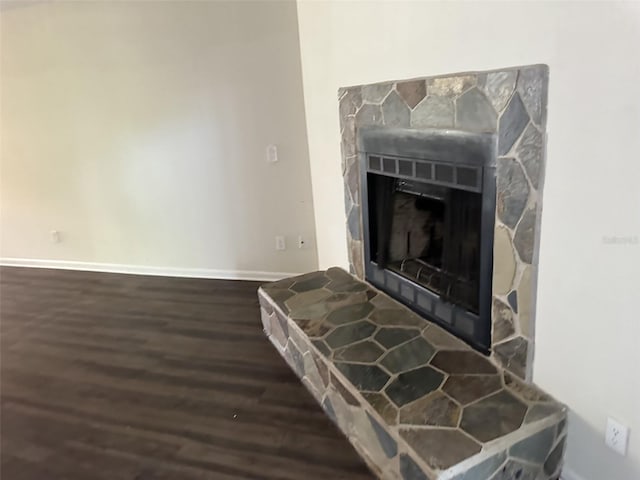 details featuring dark hardwood / wood-style flooring and a fireplace