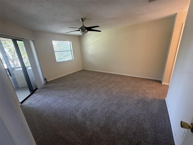 carpeted empty room featuring ceiling fan, a healthy amount of sunlight, and a textured ceiling