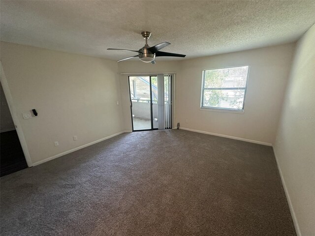 carpeted empty room featuring ceiling fan and a textured ceiling