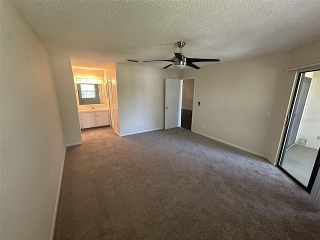 interior space featuring ceiling fan, carpet flooring, and a textured ceiling