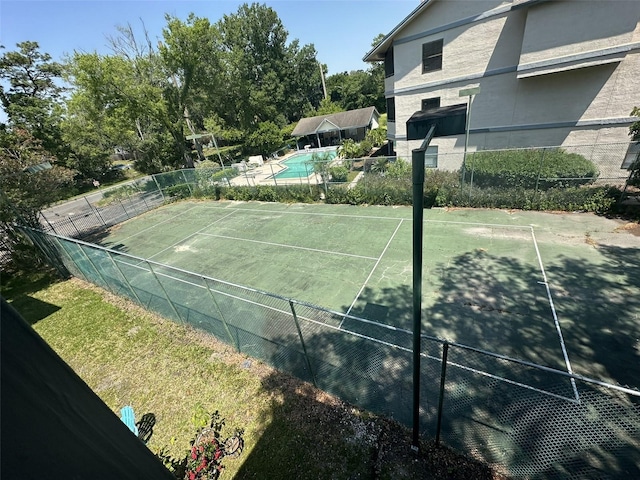 view of sport court with a fenced in pool