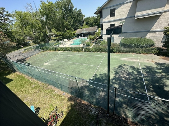 view of sport court with a fenced in pool