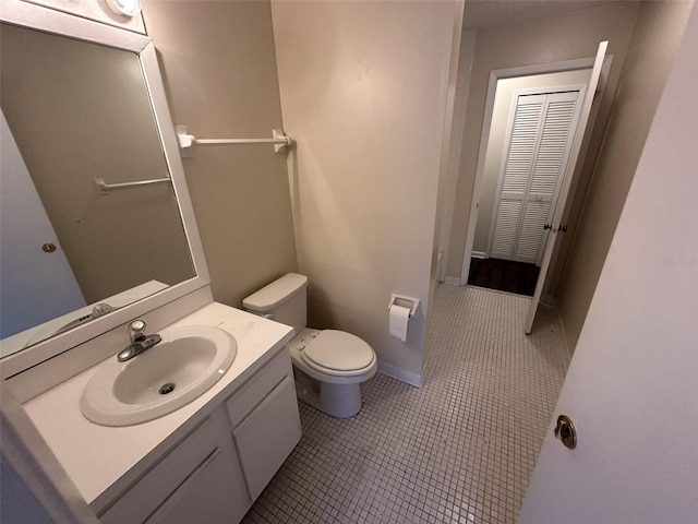 bathroom featuring tile floors, oversized vanity, and toilet