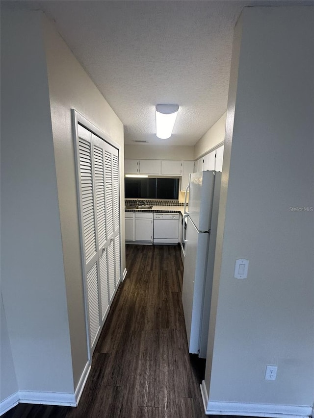 interior space with dark hardwood / wood-style floors and a textured ceiling