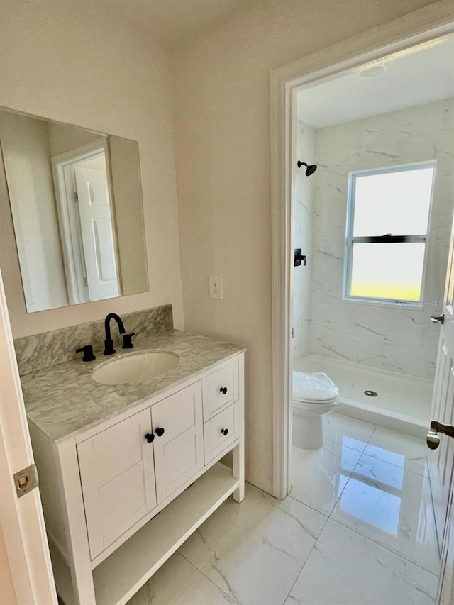 bathroom with toilet, tile flooring, vanity, and a tile shower