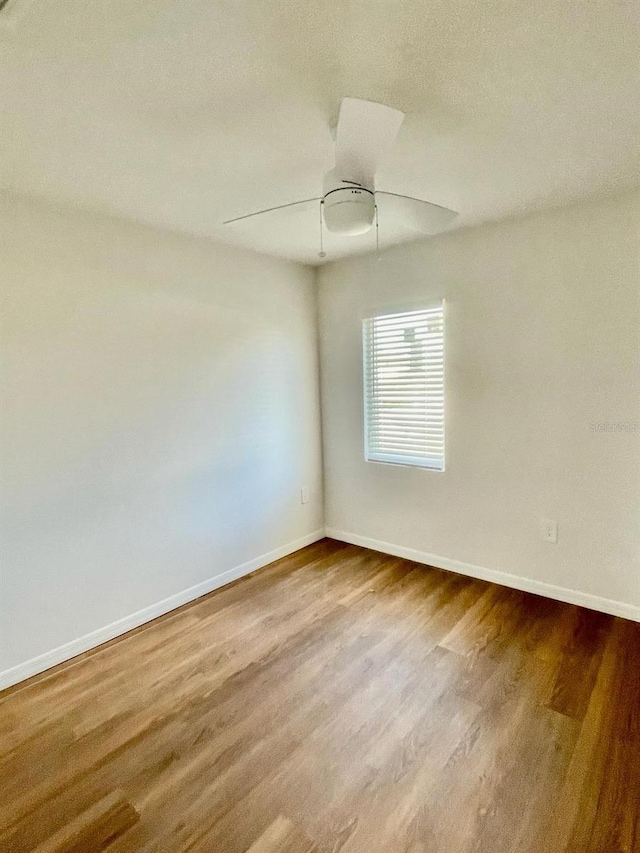 empty room featuring wood-type flooring and ceiling fan