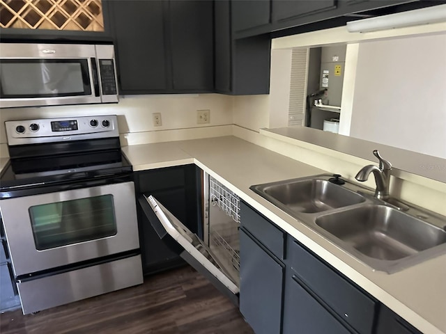 kitchen featuring sink, stainless steel appliances, and dark hardwood / wood-style floors