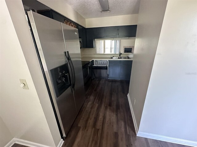 kitchen with stainless steel fridge with ice dispenser, sink, dark hardwood / wood-style floors, and a textured ceiling