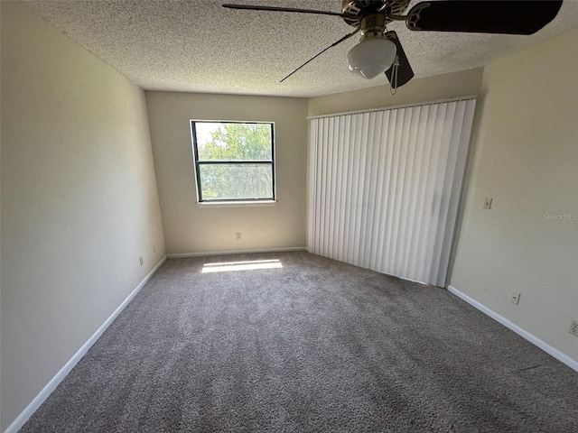 carpeted empty room featuring a textured ceiling and ceiling fan