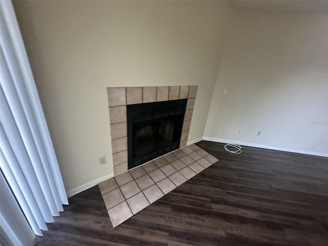 room details with dark hardwood / wood-style flooring and a tile fireplace