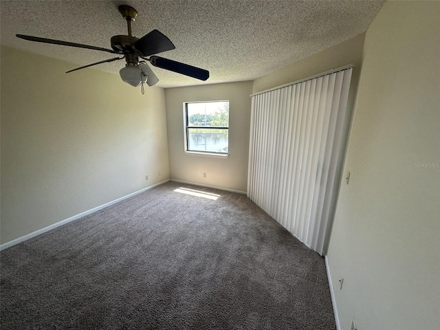 unfurnished room featuring ceiling fan, carpet flooring, and a textured ceiling