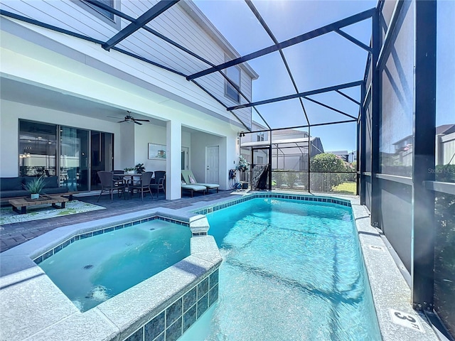 view of pool featuring a lanai, an in ground hot tub, a patio area, ceiling fan, and an outdoor hangout area