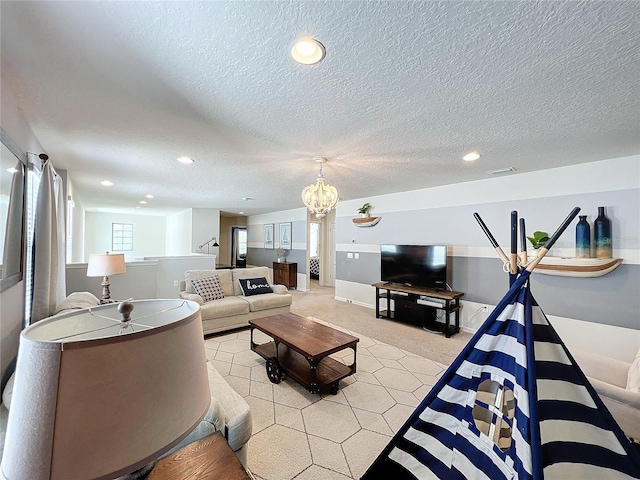 living room featuring light colored carpet, a textured ceiling, and an inviting chandelier