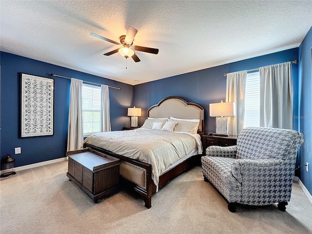 bedroom featuring a textured ceiling, carpet floors, and ceiling fan