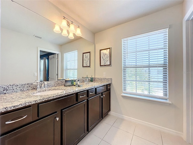 bathroom featuring vanity with extensive cabinet space, double sink, and tile flooring