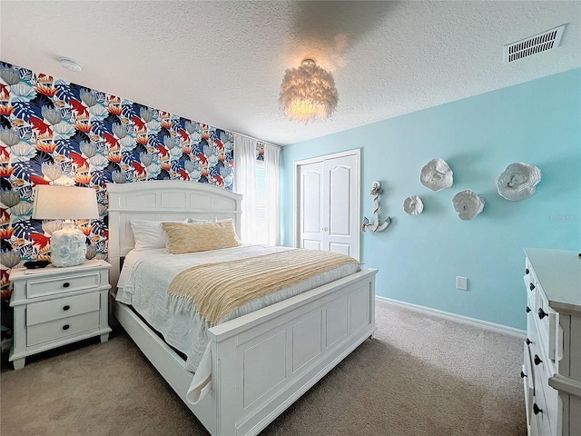 bedroom featuring a closet, a textured ceiling, and carpet flooring