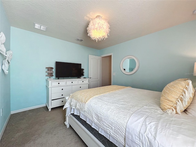 bedroom with carpet and a textured ceiling