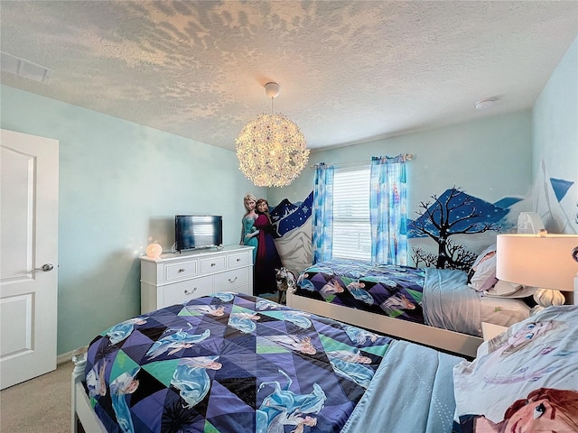 bedroom with light colored carpet and a textured ceiling