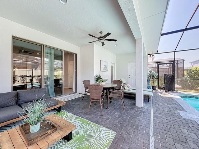 view of patio with ceiling fan and a lanai